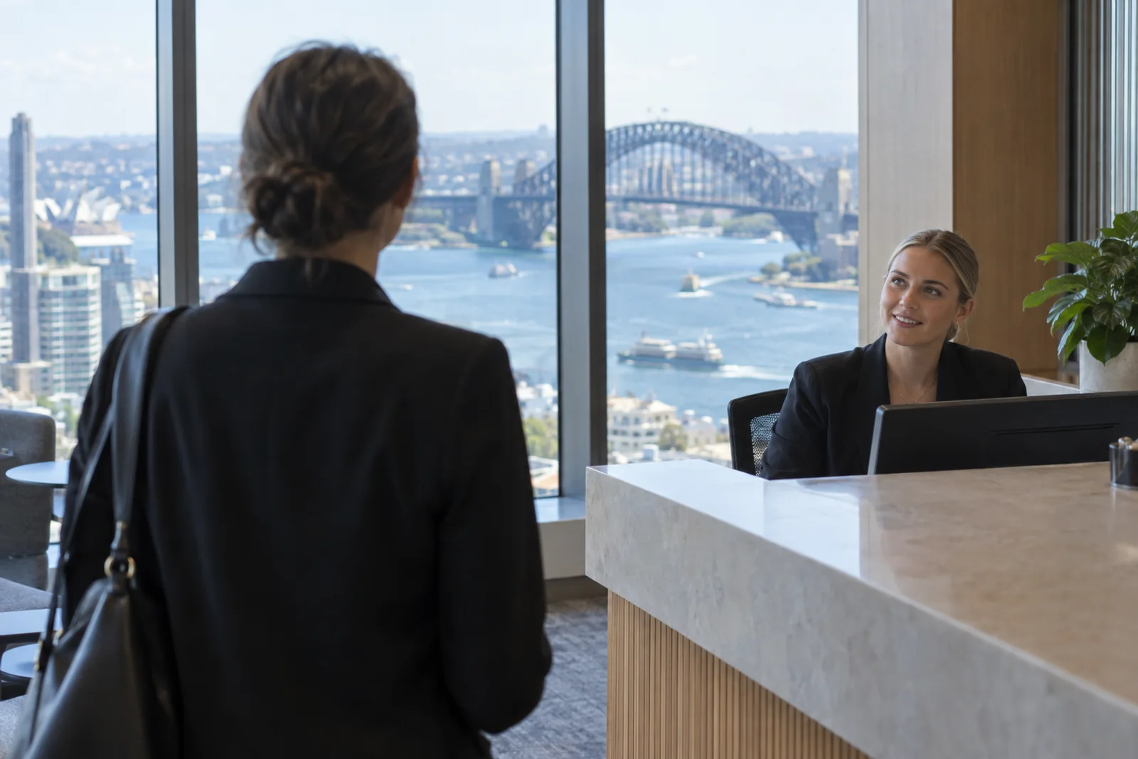 A reception desk in a Sydney tower office with the harbour bridge through the window.