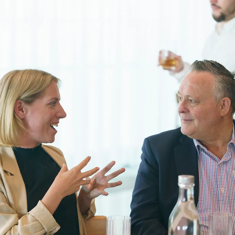 Two event participants sharing a conversation.